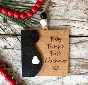 Detail of wooden Merry Christmas Mommy and Daddy ornament with Baby Bump 2023 text