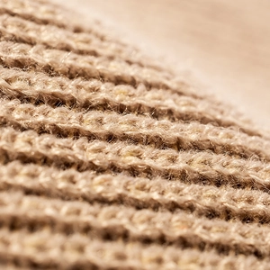 Oatmeal knit beanie close-up showing thick ribbed texture and soft thermal wool material