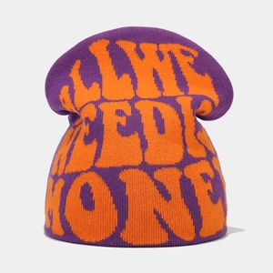 Detail view of the purple and orange jacquard knit beanie with soft textile texture