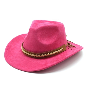 Detail of fuchsia suede cowboy hat with braided leather band and decorative tassels