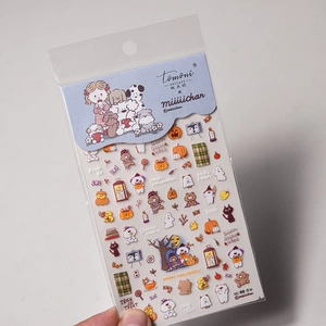 Detail of Halloween nail art stickers with pumpkin, ghost, and dog motifs on packaging