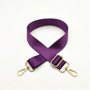 Detail of adjustable purple nylon shoulder strap with gold-tone swivel metal lobster clasps