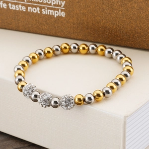Detail of beaded titanium steel bracelet with sparkling rhinestone balls on gift box