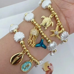 Bohemian gold beaded bracelet set with starfish, sea turtle, and shell charms for women
