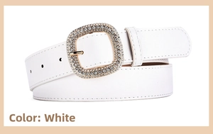 Detail of white leather belt showing a golden square buckle with sparkling rhinestones