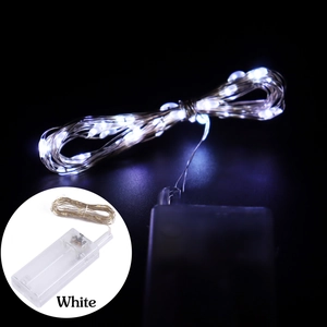 Close-up of white LED copper wire string lights with a transparent battery box unit