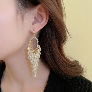 Luxurious gold-tone tassel earrings with sparkling crystals and silver needle studs