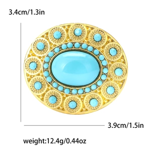 Detail of turquoise oval brooch with gold relief and specific size dimensions displayed