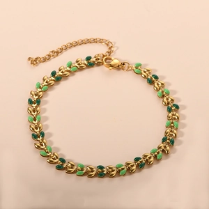 Detail of 18K gold-plated stainless steel leaf bracelet with green enamel inlays