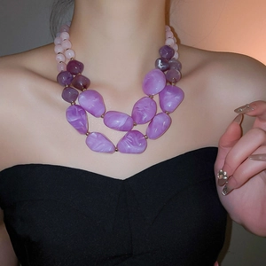 Detail of bohemian double-layered acrylic irregular violet pendant necklace on neck