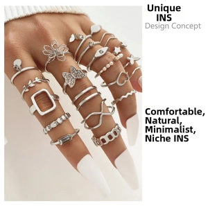 Detail view of 15pcs silver butterfly and pearl stacking rings set worn by model