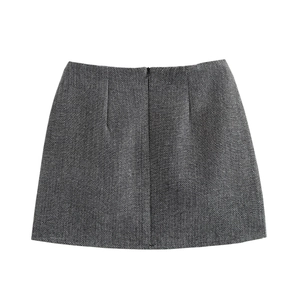 Detail of grey herringbone wool A-line mini skirt with a hidden back zipper closure