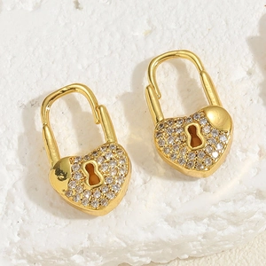 Close-up of 14K gold-plated heart lock earrings with zircon eye and pearl detail
