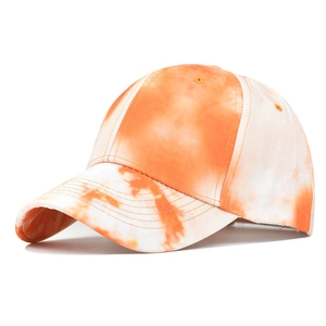 Detailed view of the orange and white tie-dye pattern on a classic six-panel baseball cap