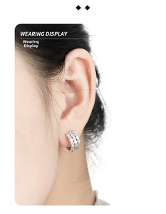 Macro view of honeycomb silver ear cuff with micro-pave zircons on a female model