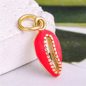 Macro detail of red enamel shell pendant with golden beaded edges on stone