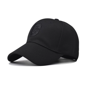 Close-up of black baseball cap featuring 3D embroidered letter C with premium fabric texture