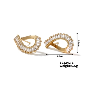 Detail view of wavy gold earrings with micro-set zircons showing 2.9cm x 1.6cm size