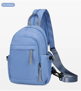 Detailed view of the blue nylon sling chest bag, showing durable fabric and zipper.