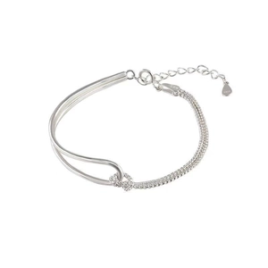 Macro shot of S925 sterling silver knotted bracelet with double chain and heart pendant