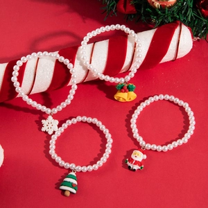 Christmas pearl bracelets with festive Santa and snowflake charms on a candy cane