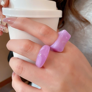 Detailed macro of two purple translucent acrylic rings in square and round shapes