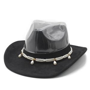 Detail of black suede cowboy hat with double-row pearl band and gold accents