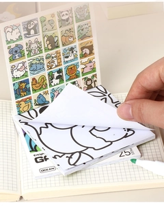 Detail showing hand flipping through 25 pages of cartoon animal coloring book for kids