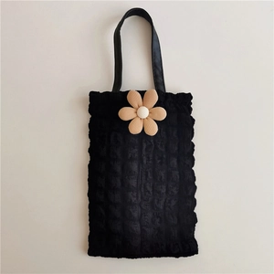 Detail of black bubble texture fabric car tissue box cover with a beige fabric flower