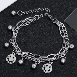 Detail of silver layered bracelet with smiley pendants and Love Me engraving