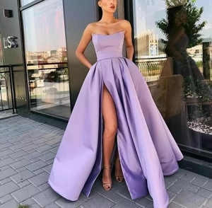 Detail of lavender satin evening dress with strapless neckline and high leg slit
