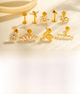 Detail of titanium alloy body jewelry with zircon bird and dragonfly designs