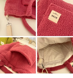 Detail of rose red faux shearling tote bag with interior lining and durable strap