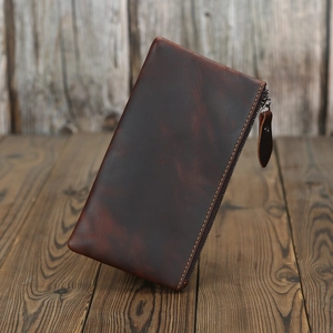 Close-up of vintage brown crazy horse leather wallet featuring a durable zipper puller