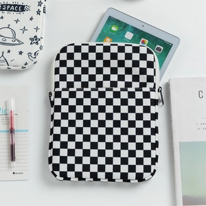 Detail of checkered padded laptop sleeve with front pocket and zipper closure