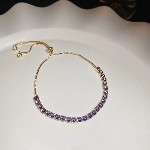 Macro shot of 18K gold plated bracelet with purple round crystals and adjustable slider