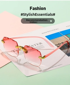 Detail of pink gradient rimless sunglasses with gold metal hinges on a fashion magazine