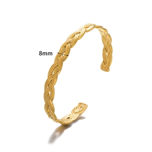Detailed view of 8mm wide gold braided stainless steel cuff bracelet with textured weave
