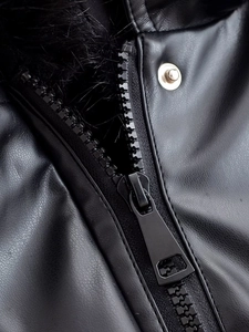 Detailed close-up of premium black PU leather texture with metal zipper and faux fur collar