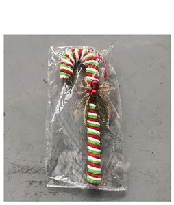 Detail view of red white and green striped Christmas candy cane in clear packaging