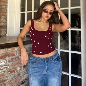 Detail of burgundy knitted crop top with pearl embellishments and elegant U-neck design