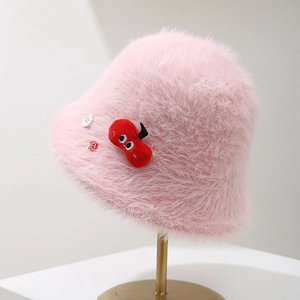 Close-up of a pink fuzzy bucket hat featuring a cute cartoon cherry patch and button detail