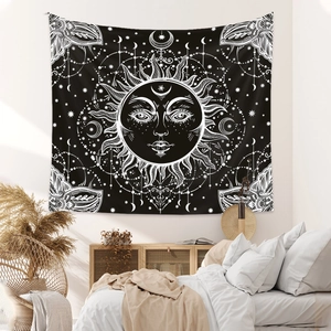 Detail of bohemian sun and moon tapestry hanging on a white bedroom wall for room decor
