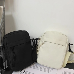 Minimalist nylon crossbody bag for men and women in classic black and cream white