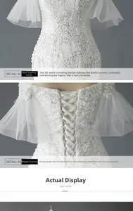 Detail view of lace-up back and floral embroidery on bridal wedding gown with bell sleeves