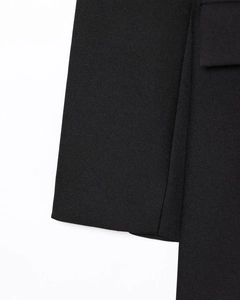 Macro shot of high-quality black worsted twill fabric texture on a longline blazer