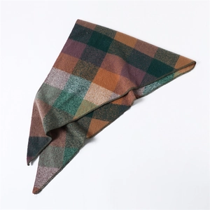 Detailed macro view showing the soft texture and vibrant colorful plaid pattern of the scarf