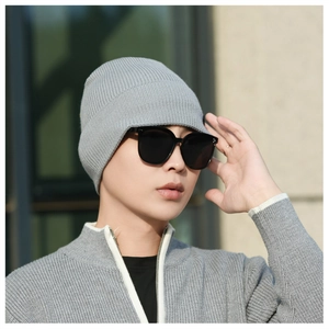 Close-up of grey ribbed knit beanie on male model featuring thick warm texture and snug fit