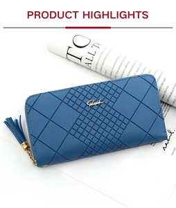 Detail of light blue textured long wallet with tassel zipper and metal logo