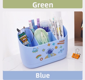 Close-up of a blue desktop organizer with astronaut stickers and three storage sections